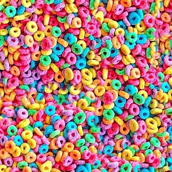A close-up view of colorful, round cereal pieces in various bright colors, including red, orange, yellow, green, blue, and purple, filling the entire image.