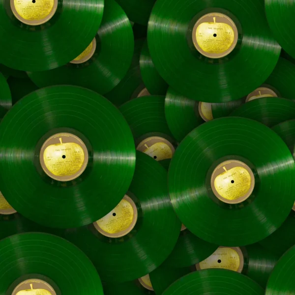 A bunch of green vinyl records with yellow apples on them.