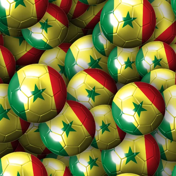 A large pile of soccer balls, each featuring the Senegal flag's colors: green, yellow, and red, with a green star in the center of the yellow portion. The balls are densely packed together, filling the entire image.