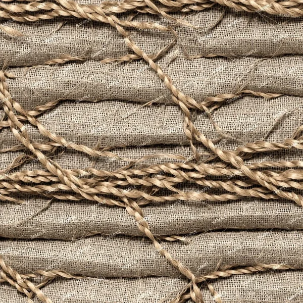 Close-up of a textured background featuring interwoven braided ropes laid across a burlap fabric surface, displaying a natural, rustic appearance with a focus on the fibers' details.