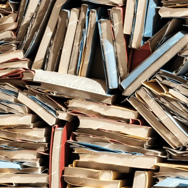 A closely packed, vertical stack of various old and worn hardcover books, showing an array of colorful spines and pages. the books are tightly compressed and appear aged.
