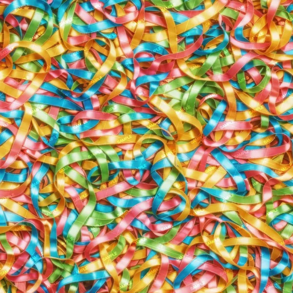A vibrant, multi-colored assortment of tightly packed ribbon strips in green, blue, yellow, and pink. Some ribbons have the word "Sample" printed on them in white text. The ribbons overlap and intertwine, creating a dense, colorful pattern.