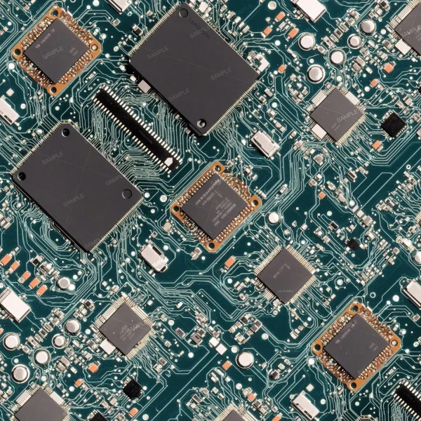 A close-up view of an electronic circuit board showcasing various integrated circuits, capacitors, resistors, and other components. The intricate network of green pathways connects different parts of the board, highlighting the complexity of the design.