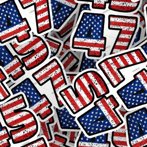 A pile of stickers featuring the numbers 17 and 47, with each number patterned in the design of the American flag. The red and white stripes cover the tops of the numbers, while the blue field with white stars covers the bottom.