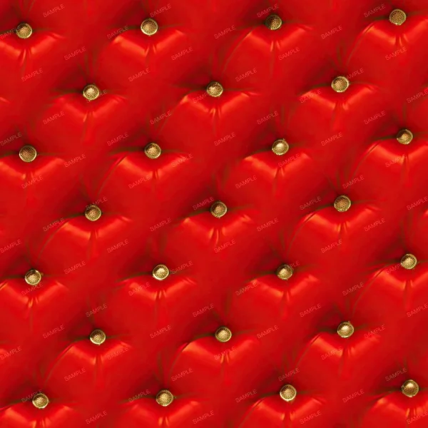 A close-up of a quilted, red leather upholstery pattern with gold buttons at each intersection. The material shows a diamond-shaped tufting design.