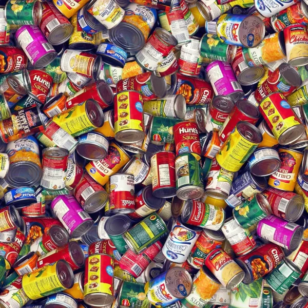 A large assortment of canned foods, such as soups, sauces, and vegetables with vibrant labels and brands, is stacked haphazardly to fill the frame. This resembles the eclectic charm captured in a "Vintage Hops Painting (Copy).