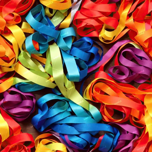 Rainbow Ribbons 25 features bundles of colorful satin ribbons—including yellow, blue, green, orange, purple, and red—loosely arranged and overlapping on a flat surface.