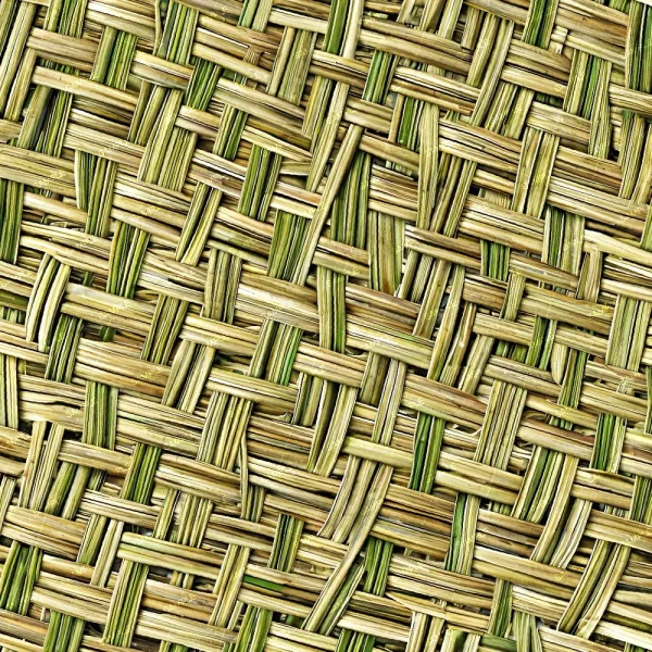 Close-up view of the Brushed Damask (Copy) mat, featuring a woven crisscross pattern made from natural fibers in beige and green hues. The textured surface appears rough and uneven.