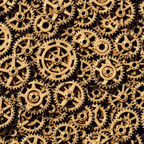 A dense arrangement of interlocking hand formed bronze tiles, featuring visible patterns and circular centers, suggests parts of a complex mechanical design.