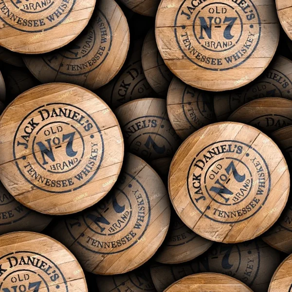 A pile of wooden barrel tops, each stamped in black ink with the Jack Daniels 23 (Copy) logo, arranged closely together to prominently display the branding.